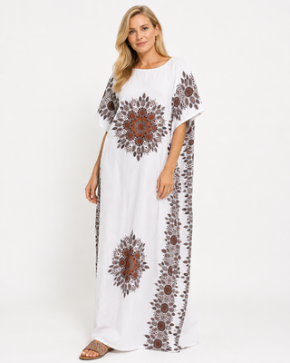 White kaftan dress with intricate brown and red patterns on the sleeves and sides