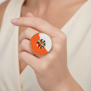 Circular gold-toned band ring with orange, white, and various multicolored beads